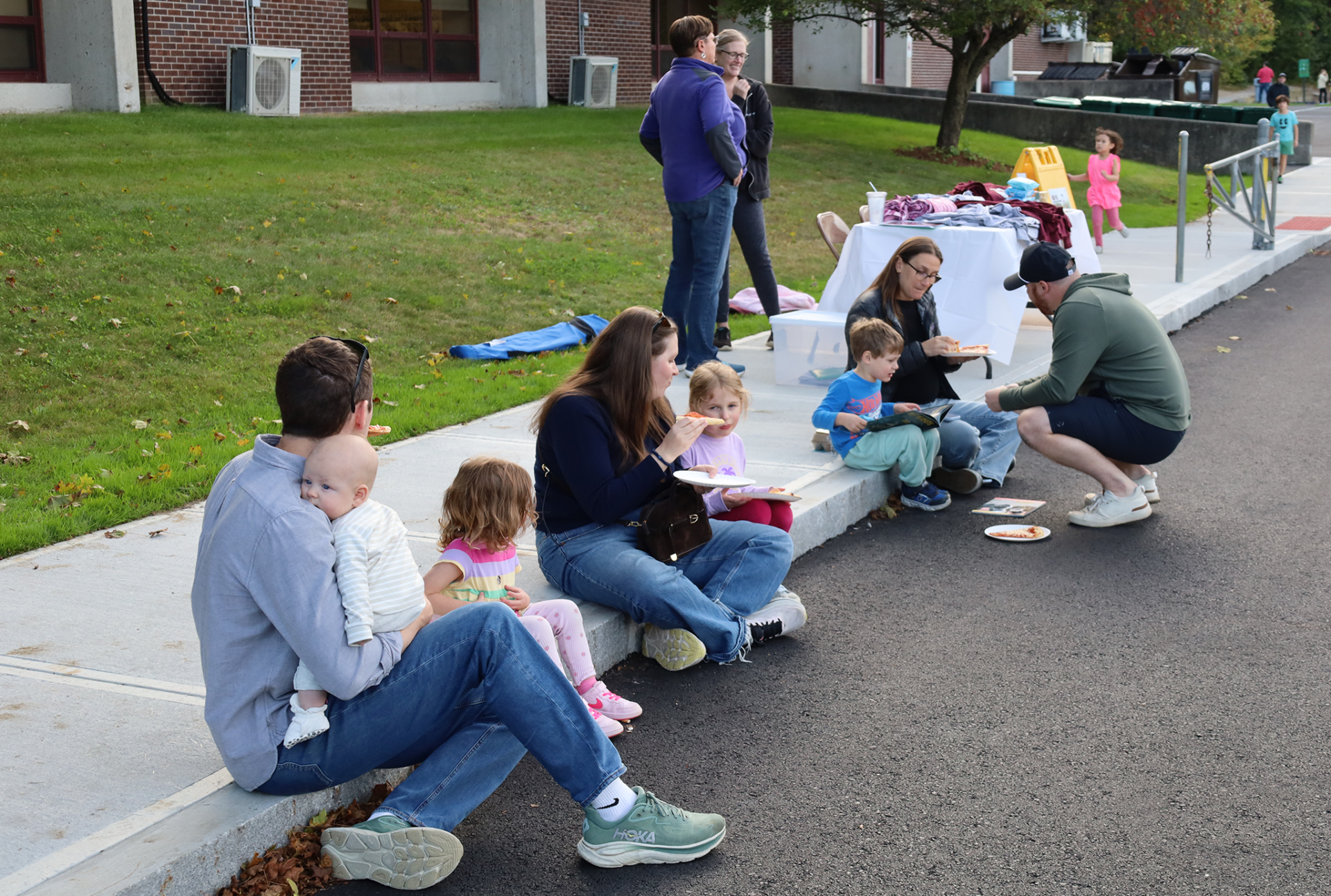 Families enjoy pizza outside Byam Elementary School during the Back To School Social on Thursday, Sept. 24, 2026.