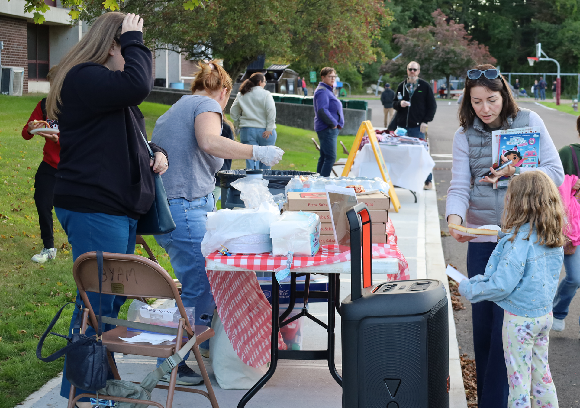 Families enjoy pizza outside Byam Elementary School during the Back To School Social on Thursday, Sept. 24, 2026.